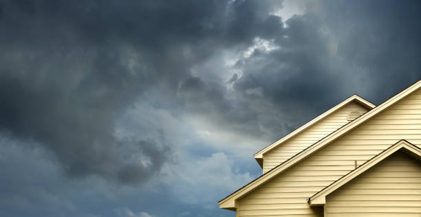 House under stormy sky representing insurance protection